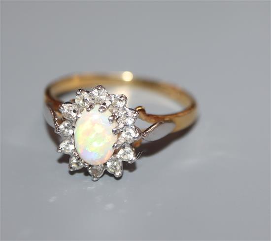 A modern 18ct gold white opal and diamond oval cluster ring, size O.